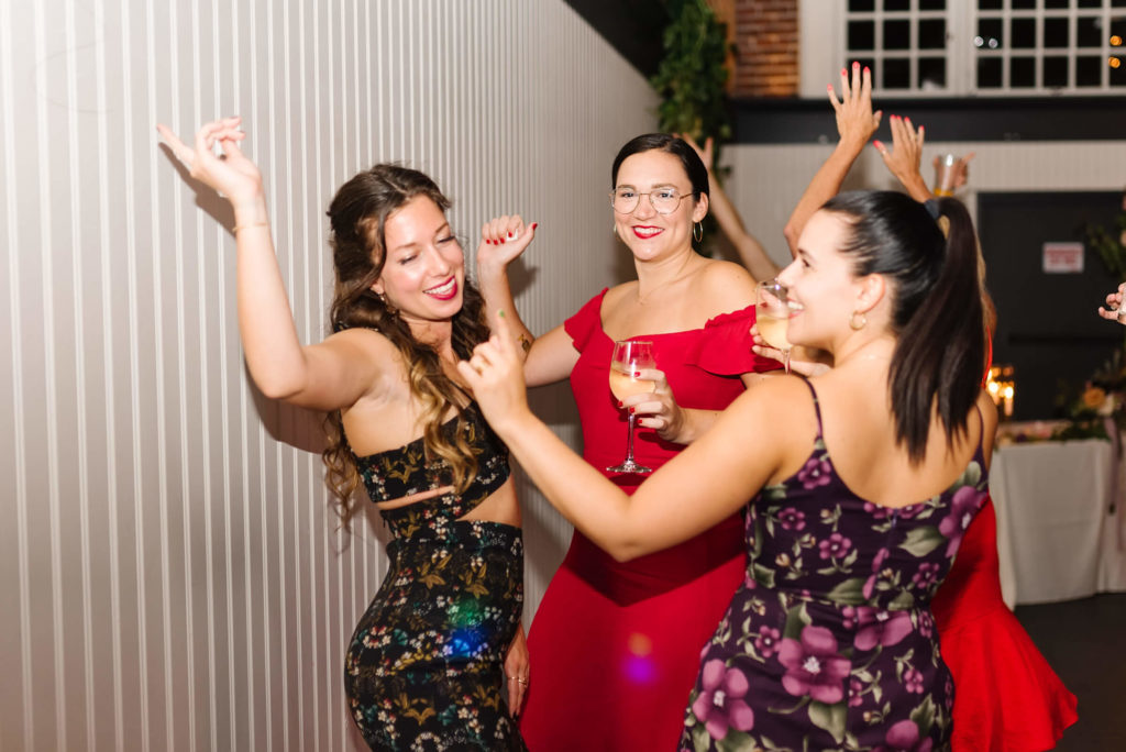 group of three girls dancing at a wedding reception
