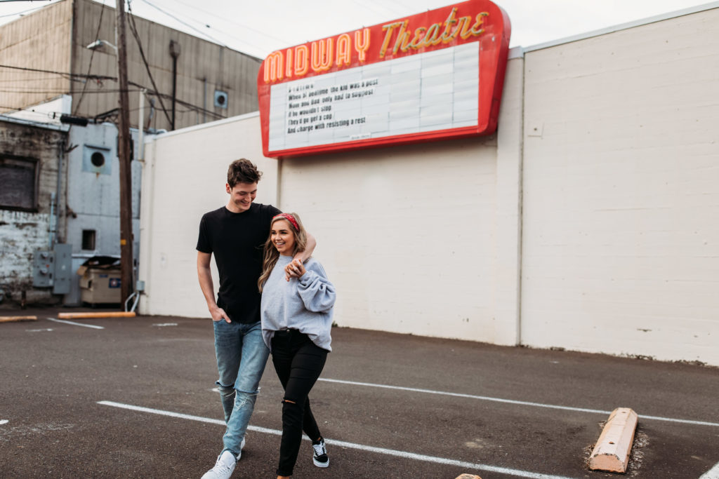 playful-couples-poses-downtown-couple-walking-through-empty-parking-lot