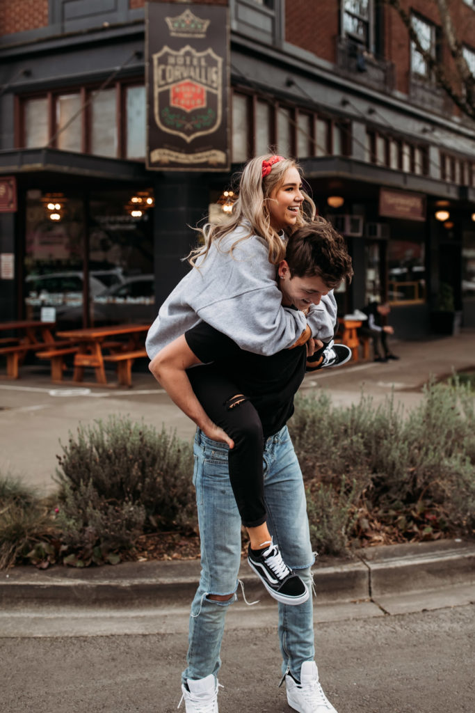 playful-couples-poses-downtown-bouncy-piggy-ride