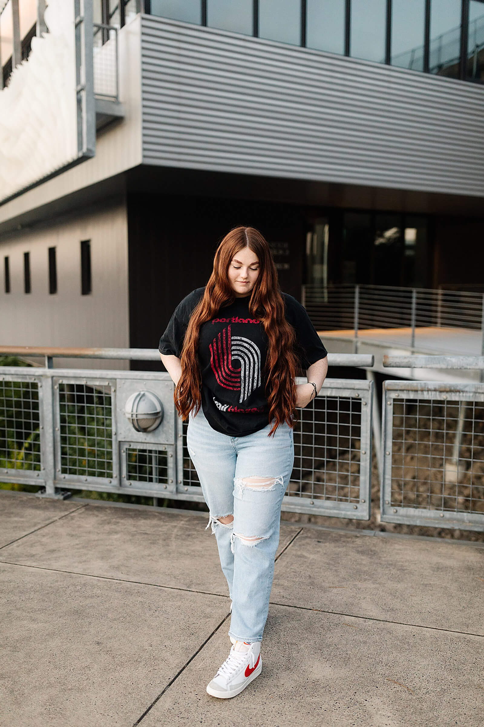 girl with red hair and vintage trail blazer t-shirt standing in downtown Portland
