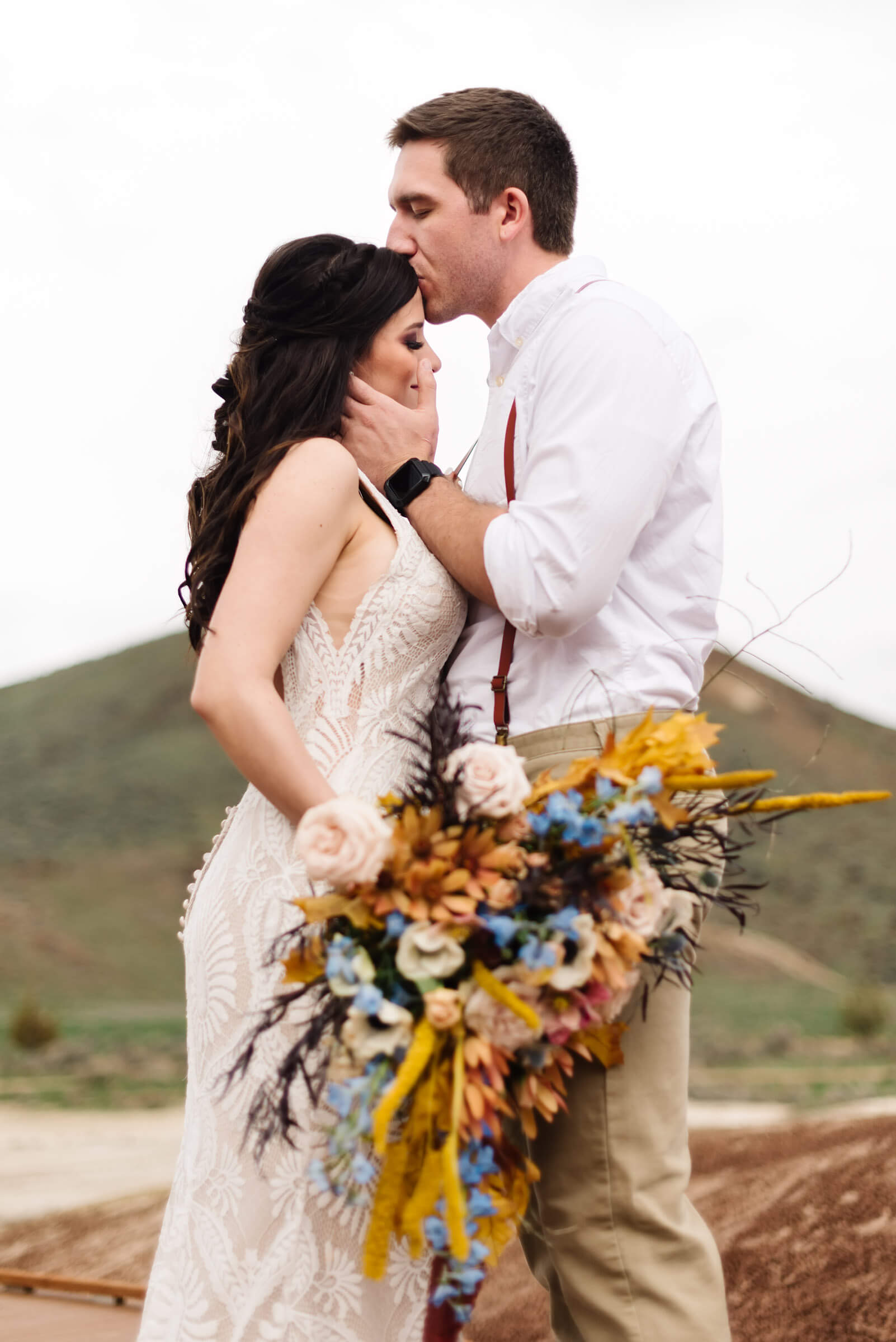 groom kissing bride on forehead during painted hills wedding portraits