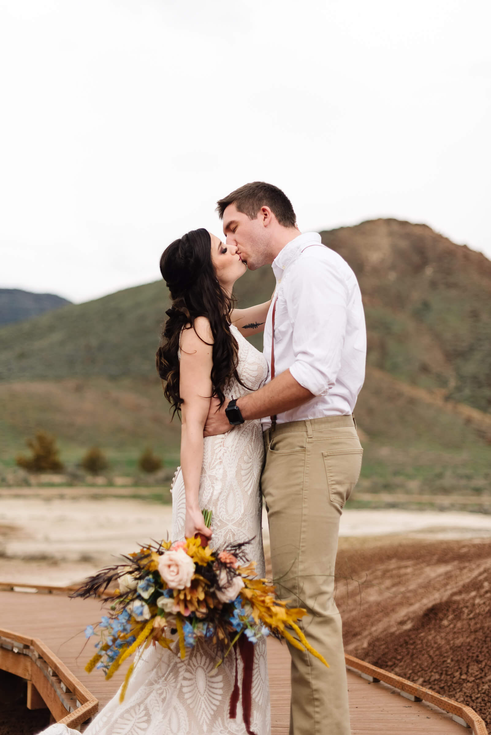 bride and groom kissing during wedding portraits at the painted hills