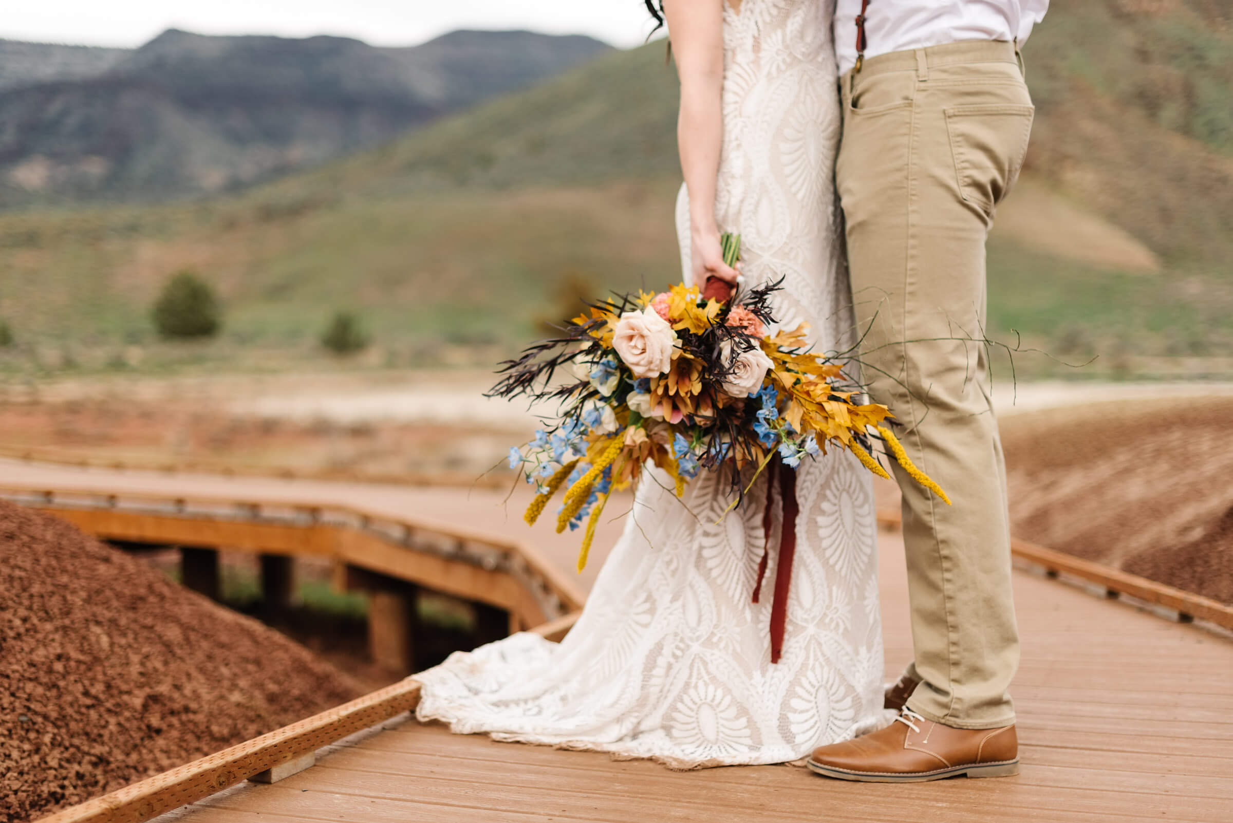 bride holding wedding bouquet during painted hills wedding portraits
