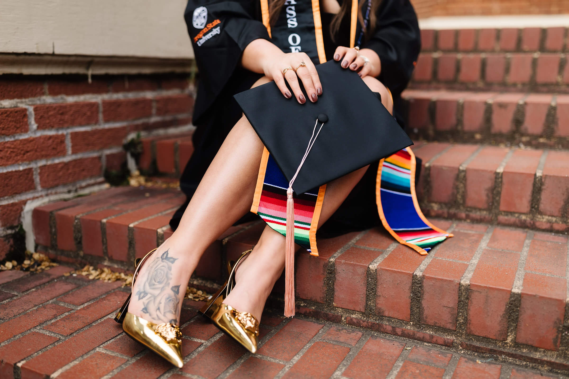 close up image of gold Versace La Medusa sling back pumps heels at Oregon State graduation picture session