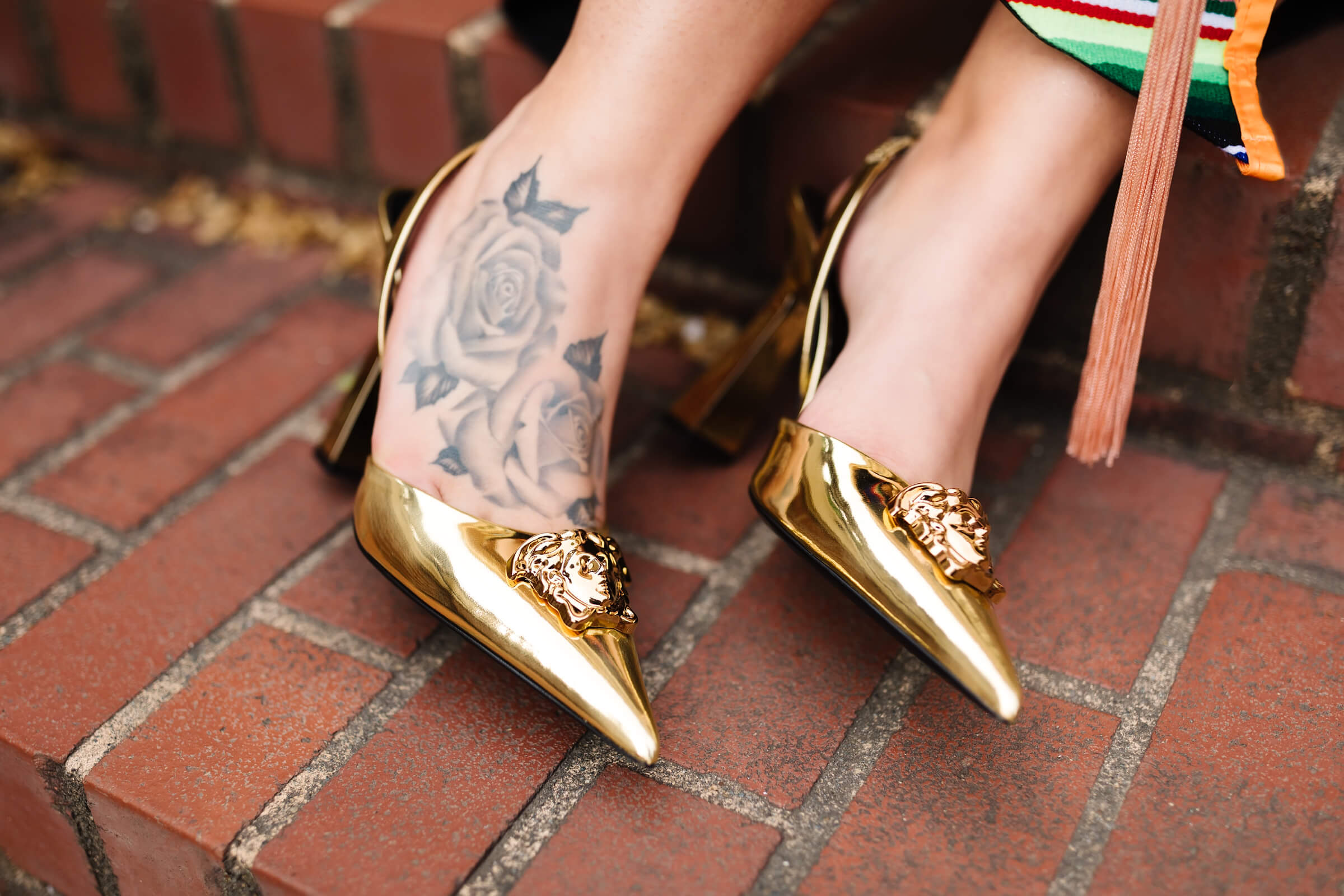 close up image of gold Versace La Medusa sling back pumps heels at Oregon State graduation picture session