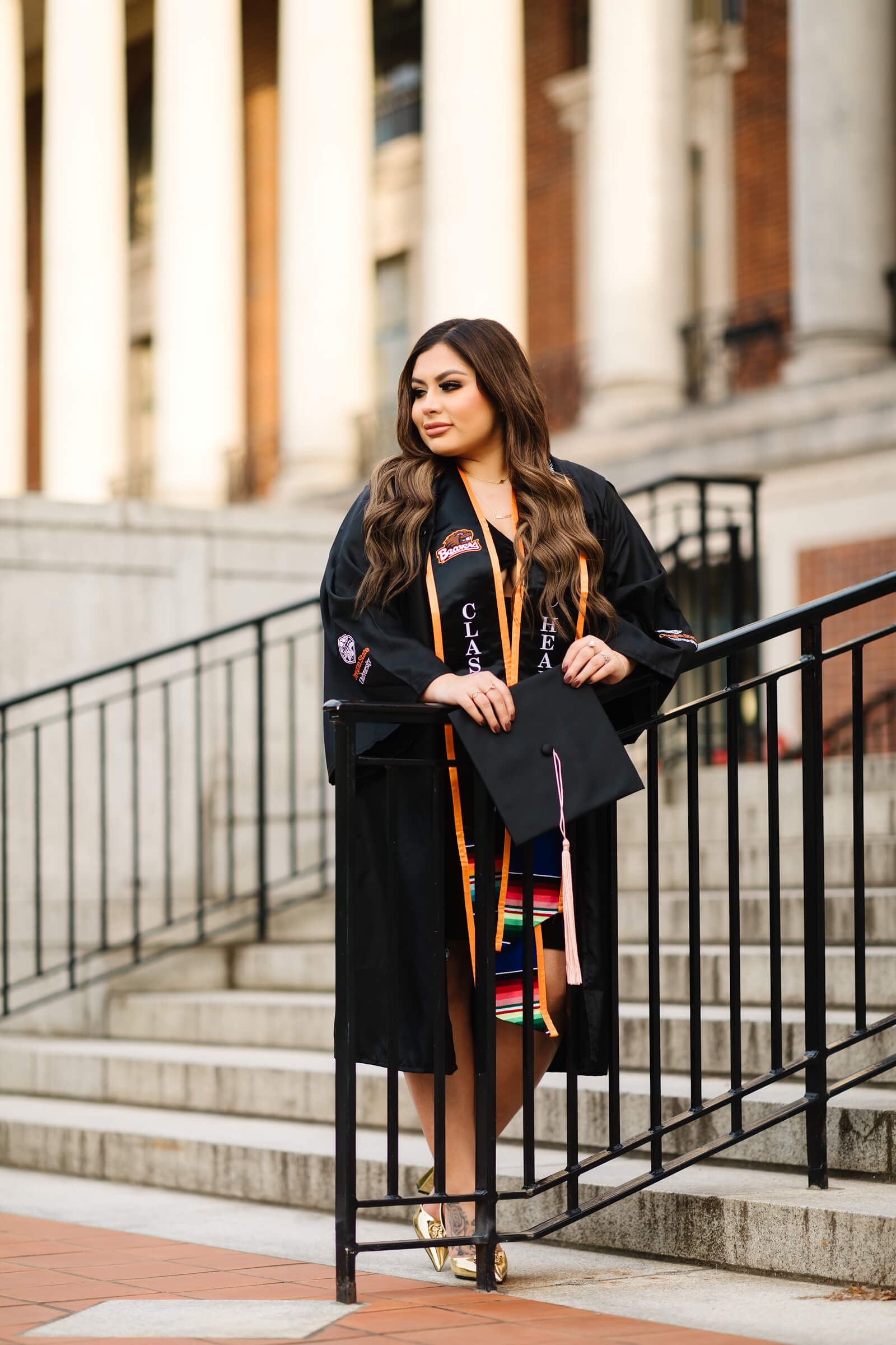 girl in Oregon State Graduation cap and gown in front of MU Building at Oregon State