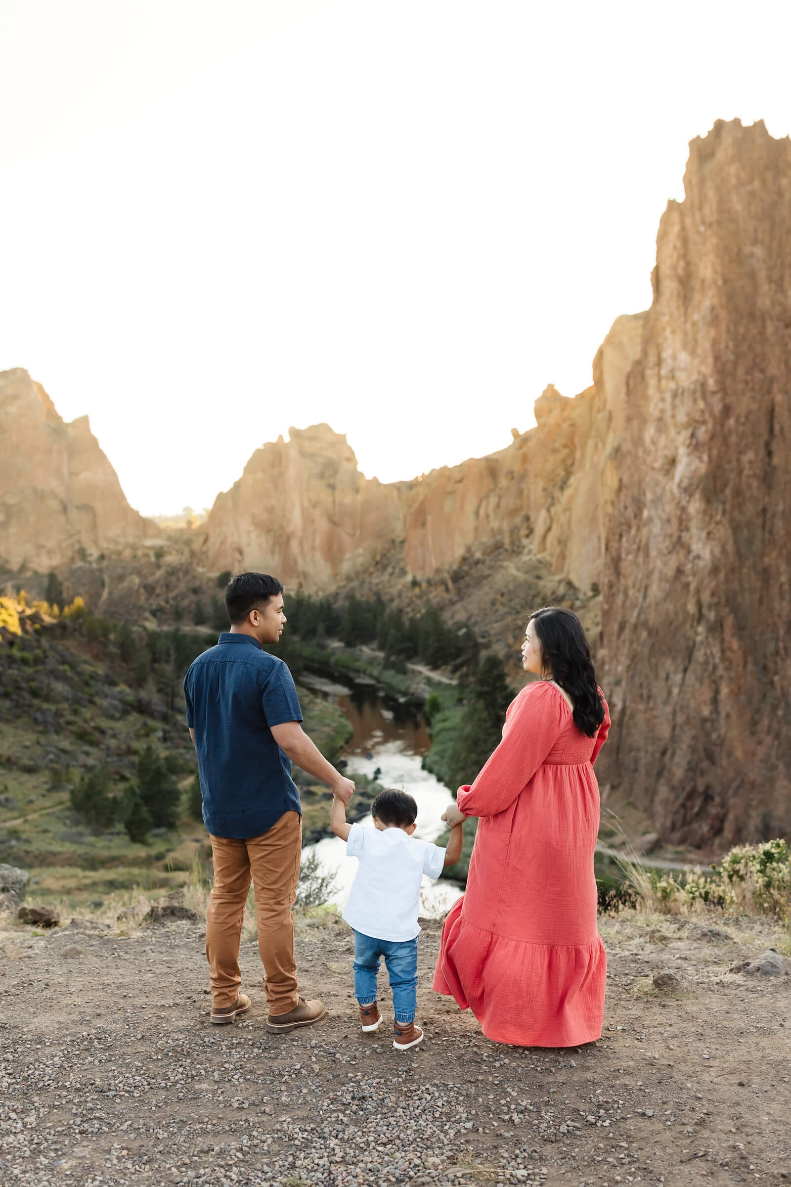 man and woman holding hands of little boy at smith rock photoshoot