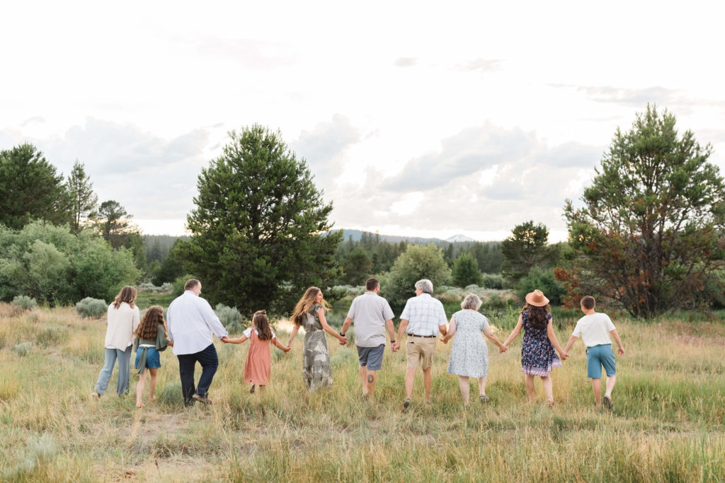 extended family walking towards the Deschutes River during extended family photoshoot
