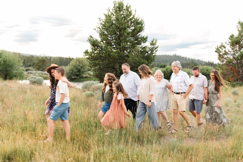 extended family walking next to the Deschutes river in Sunriver Oregon
