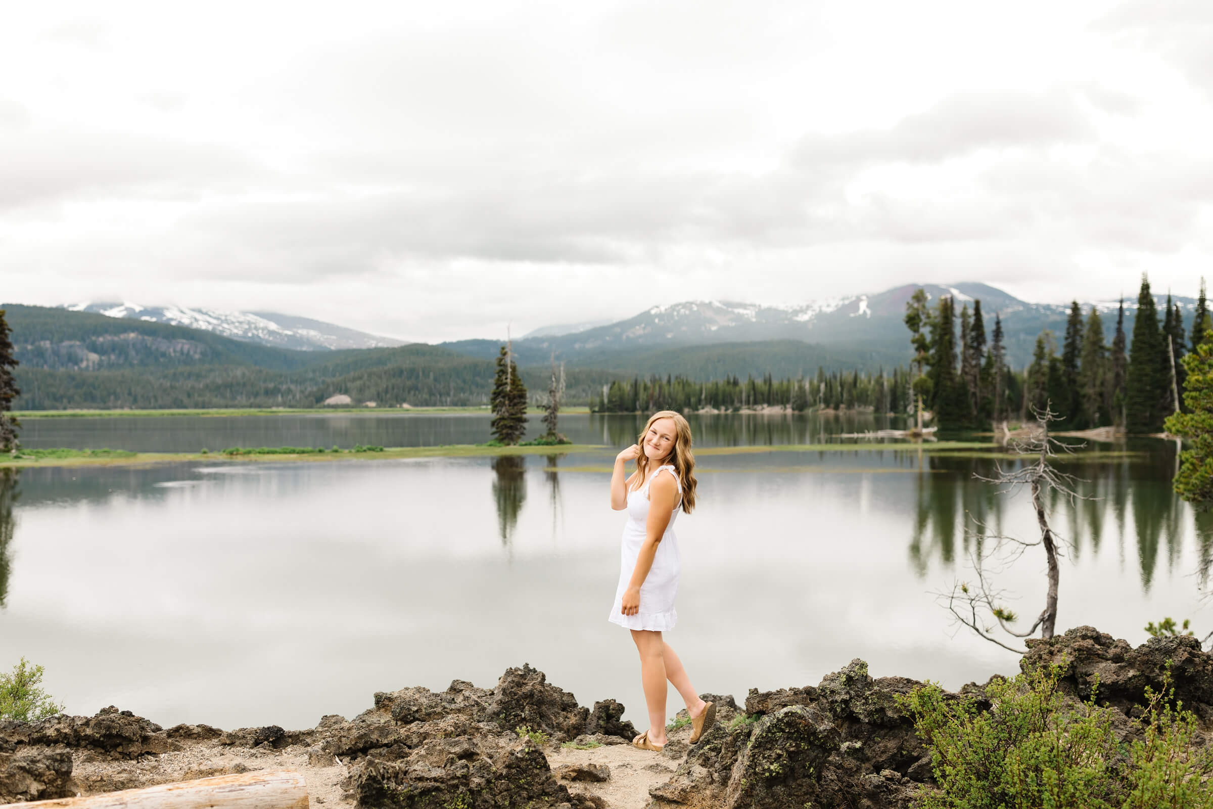 blonde girl in white dress looking over shoulder at Sparks Lake