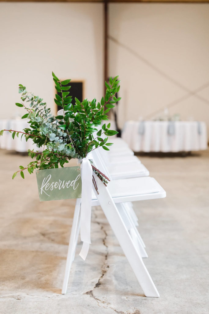 white chairs in the ceremony of the barn at countryside