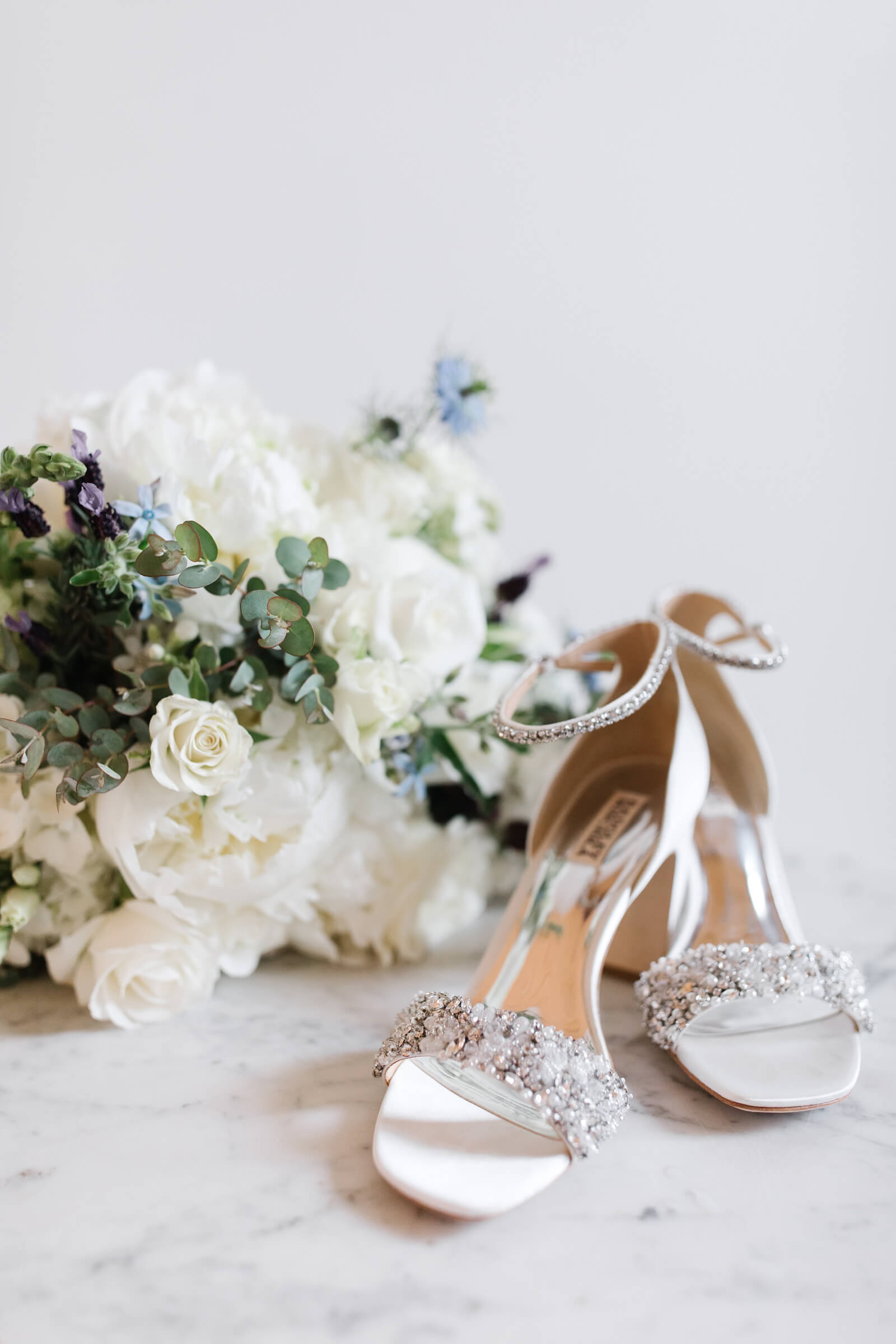jeweled white heels with white and blue bridal bouquet