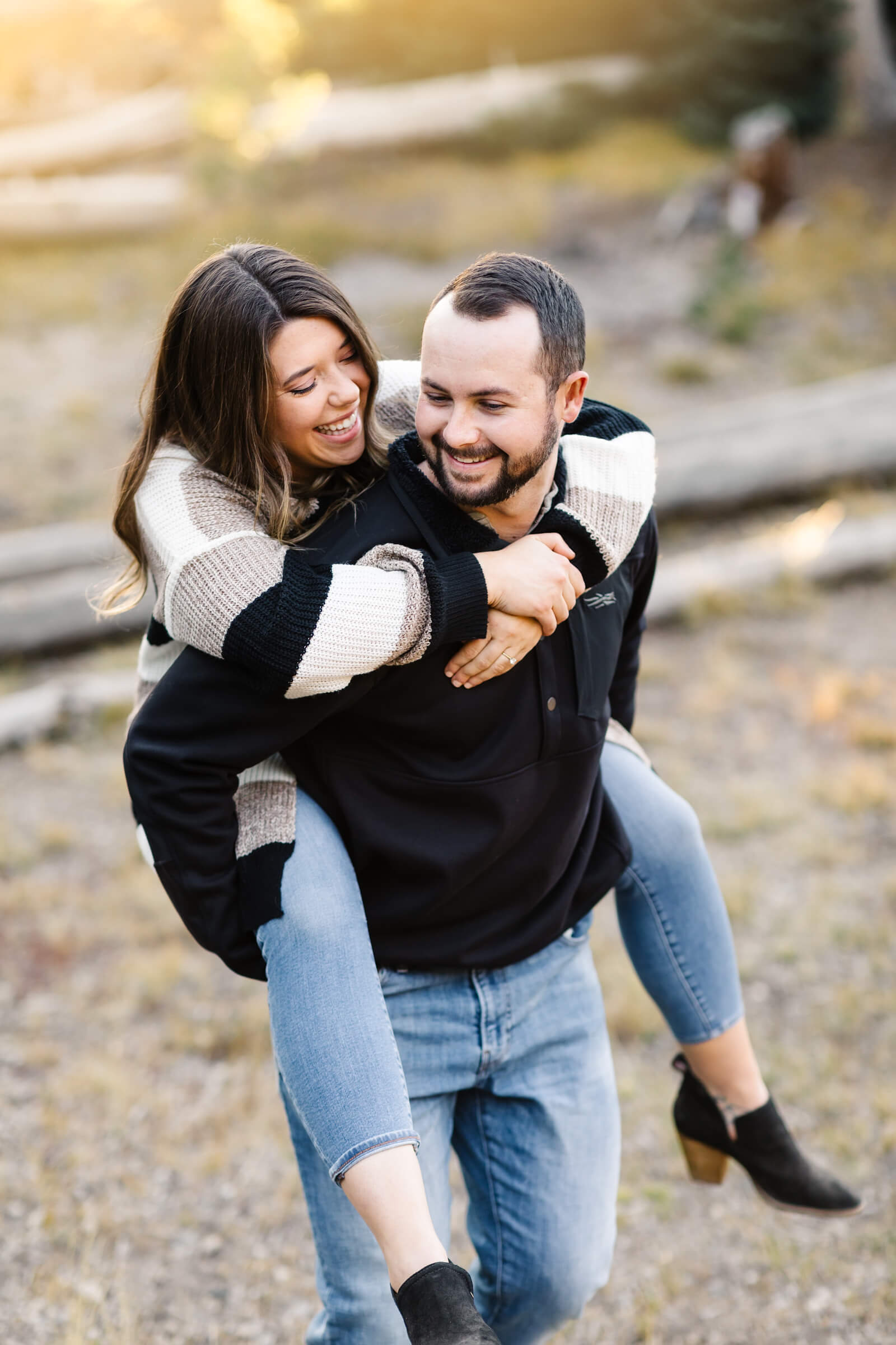 girl getting piggy back ride during engagement photos at sparks lake