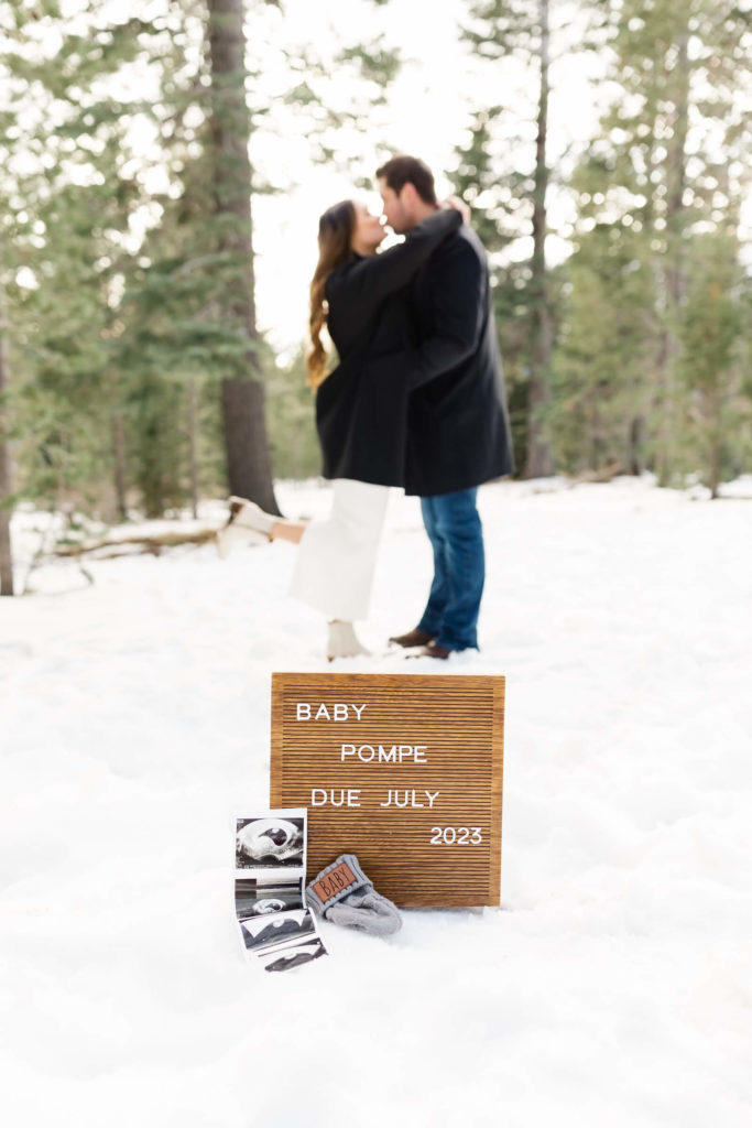 pregnancy announcement letter board with sonogram in snow