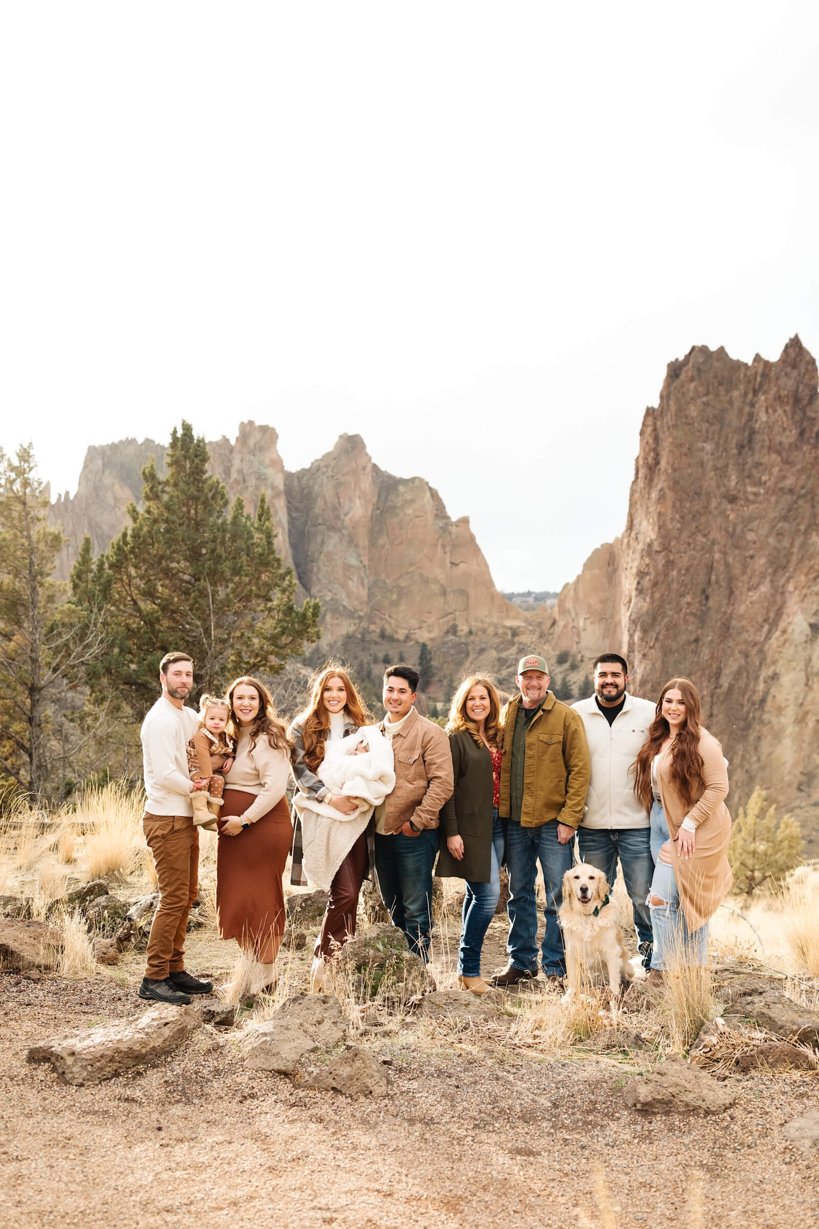 large family dressed in buckskin toned colors standing together during smith rock family photoshoot