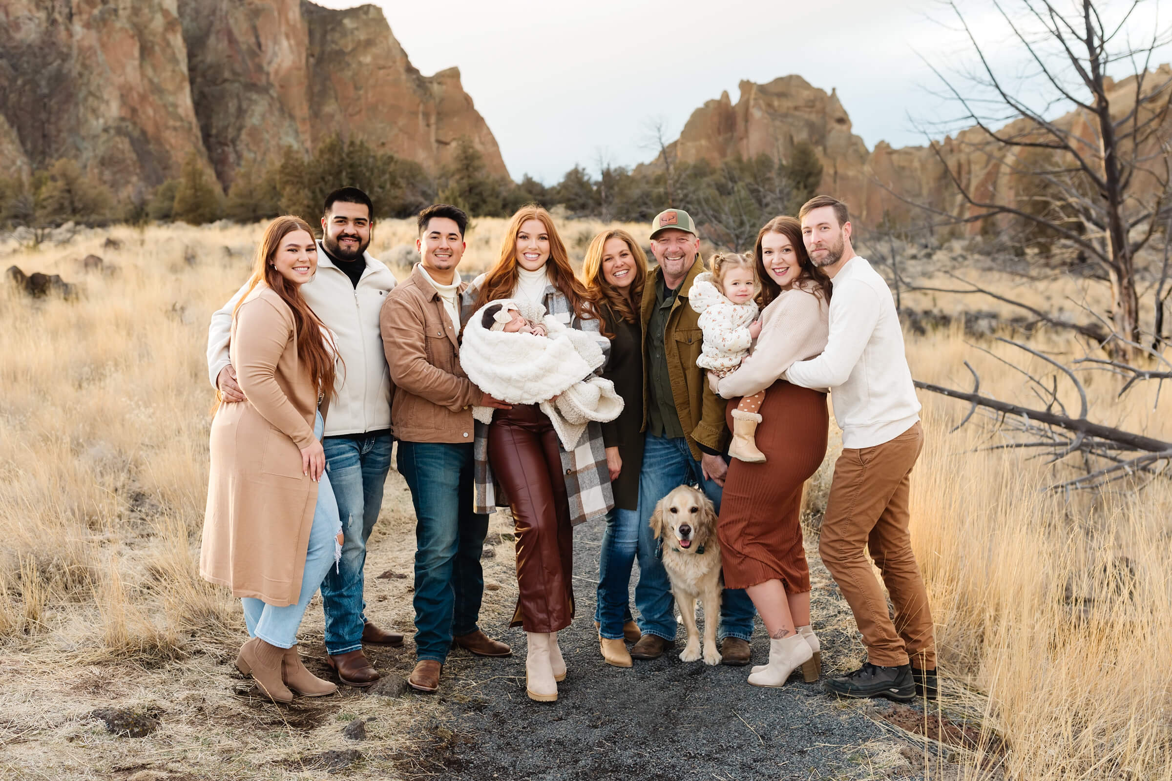 red head extended family cuddling together during smith rock family photoshoot