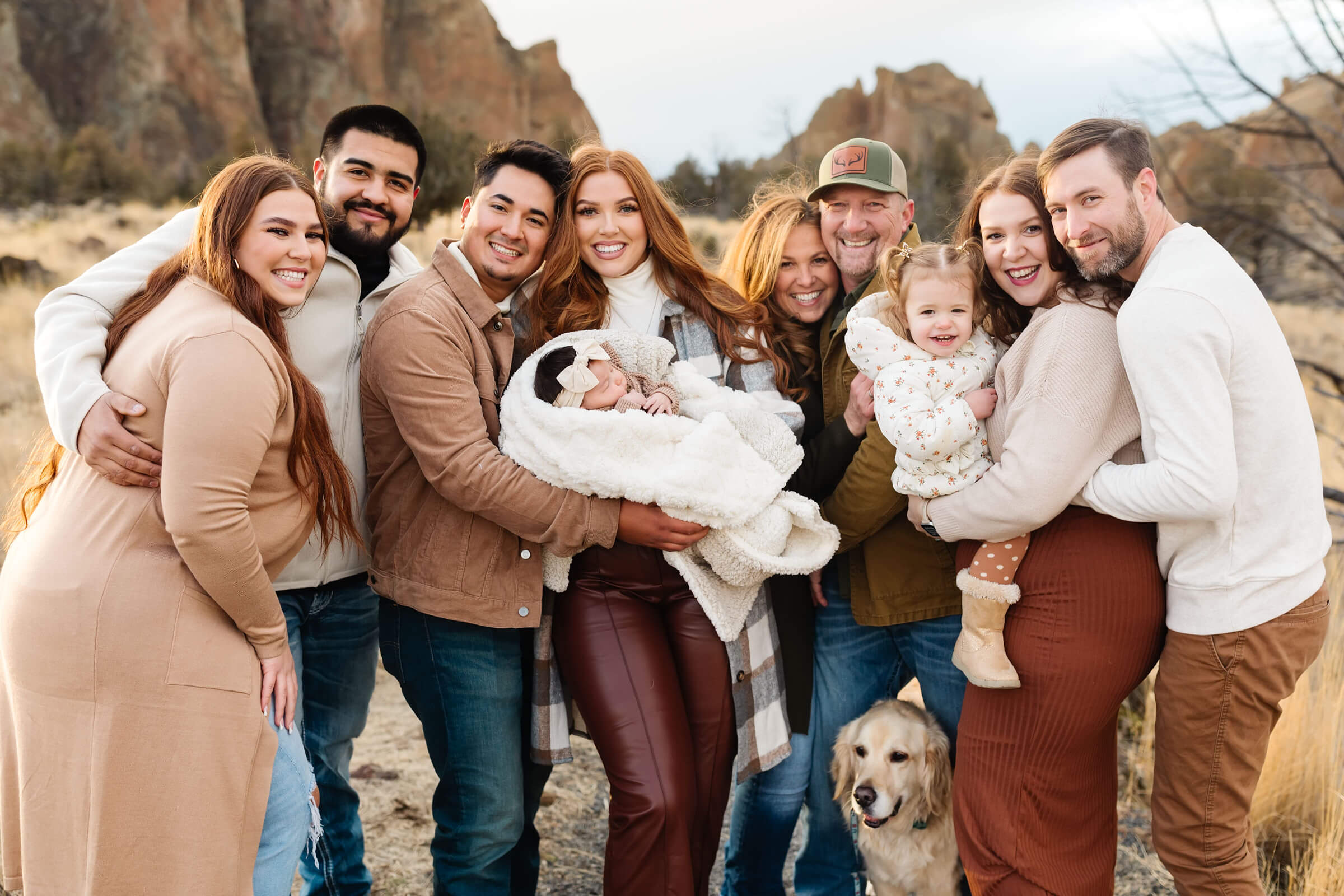 red head extended family cuddling during smith rock family photoshoot
