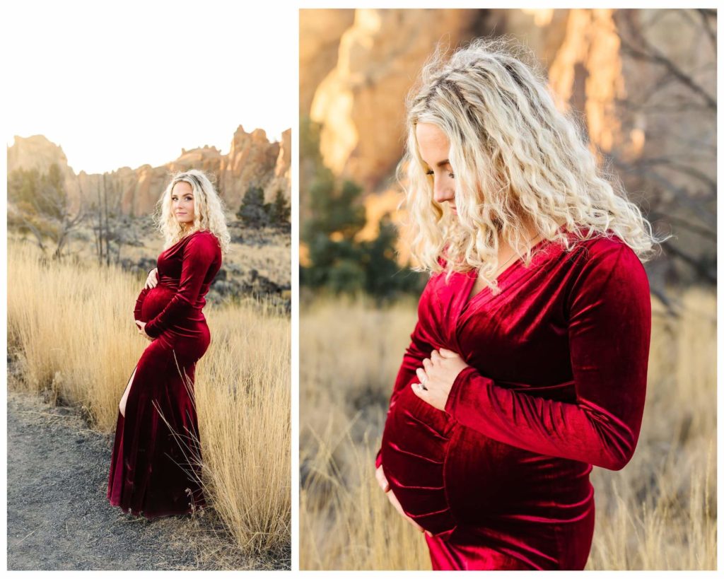 pregnant blonde woman in red velvet slit dress holding belly at smith rock during maternity photoshoot