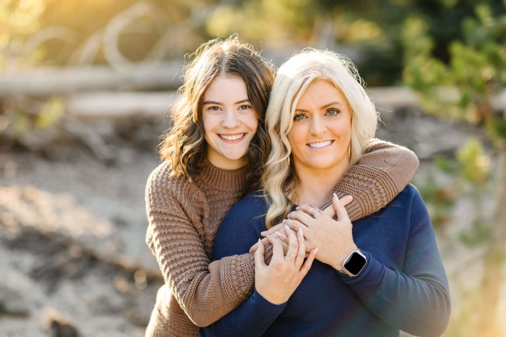 young girl hugs blonde mother during family photography session