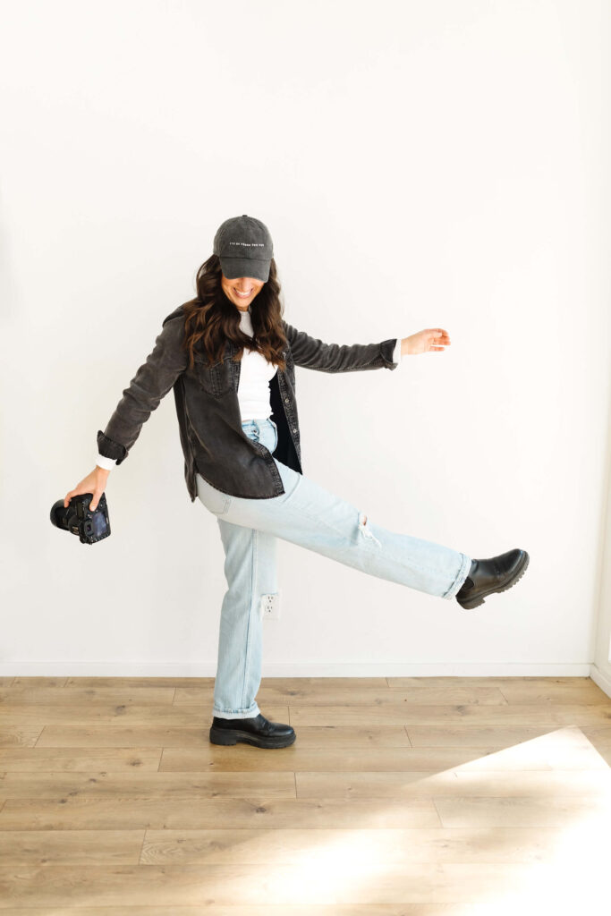 woman swinging her leg back and forth during poses for creative photographers headshots session