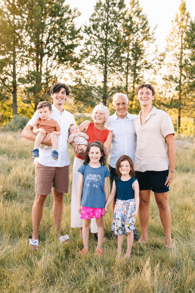 Candid moment of grandparents laughing with grandchildren during an extended family photo session in Bend.